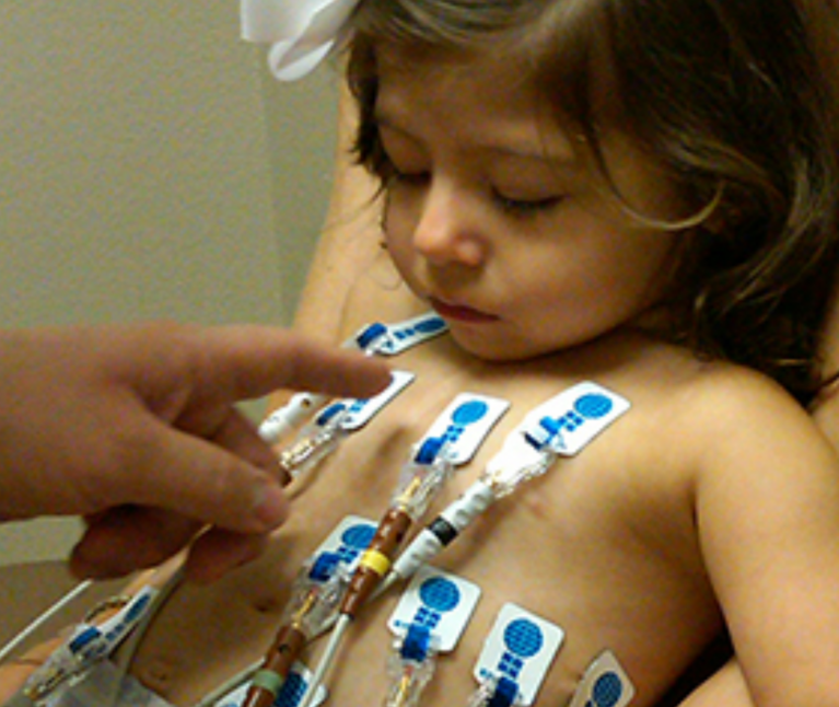 Doctor points to tubes on child's chest