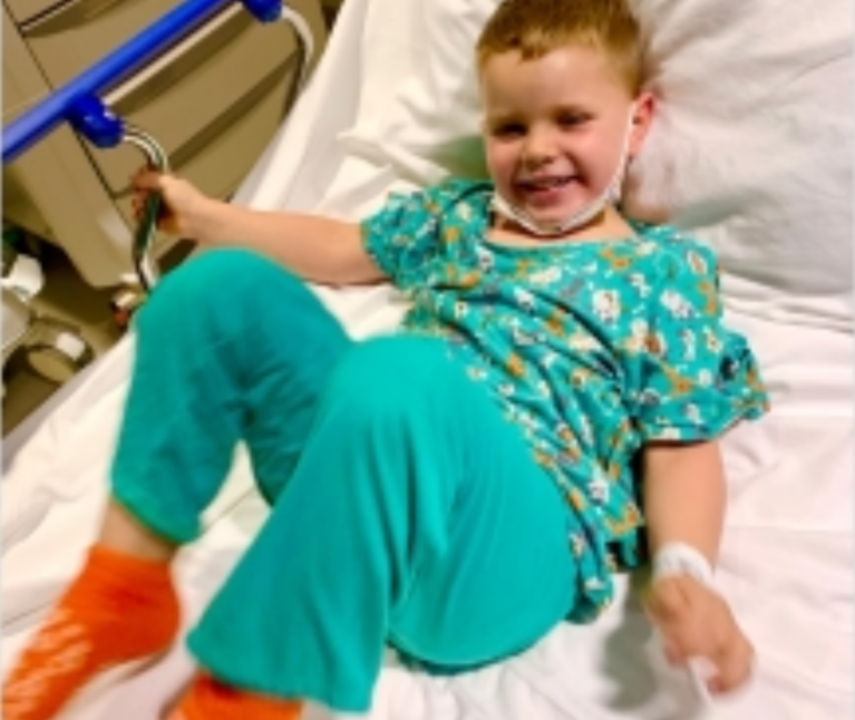 Boy smiling in hospital bed