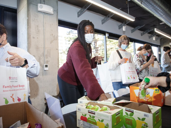 Foundation employees packing food donation bags
