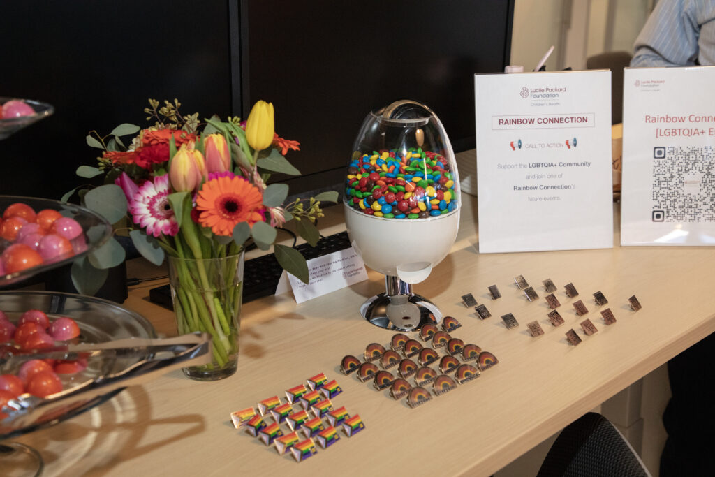 Display of pins and candy given out by foundation's LGBTQIA+ group