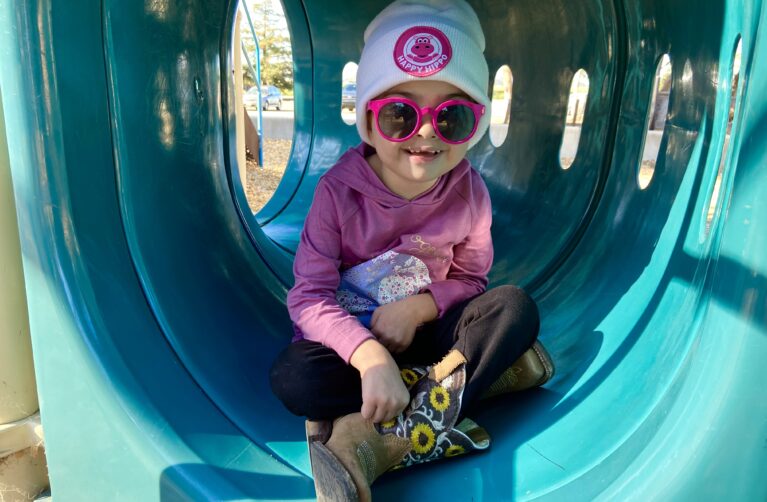 Young cancer patient at a playground