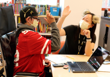 Two people giving each other a high five.