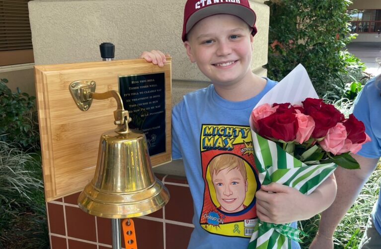 Patient max posing with a bell