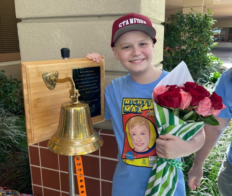 Patient max posing with a bell