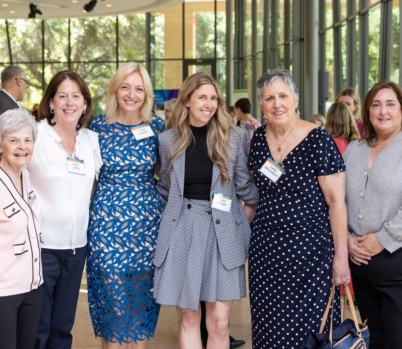 Group of auxiliary members pose with Dr Tanja Gruber at an event.