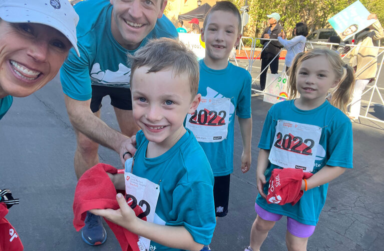 Siblings Matthew, Kate, and Alex posing with their parents at Summer Scamper.