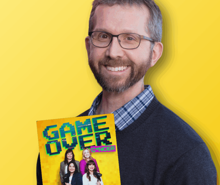 Adult pediatric cancer survivor smiling at the camera in front of a yellow backdrop. A logo of the Game Over Cancer podcast on the left-hand side.