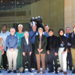 The Spiritual Care Team stands in front of the hospital.
