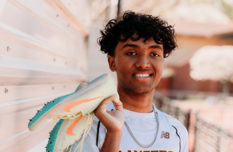 Former neurology Packard Children's patient in their high school sports uniform smiling at the camera.