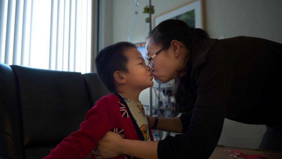 Mother kissing her son