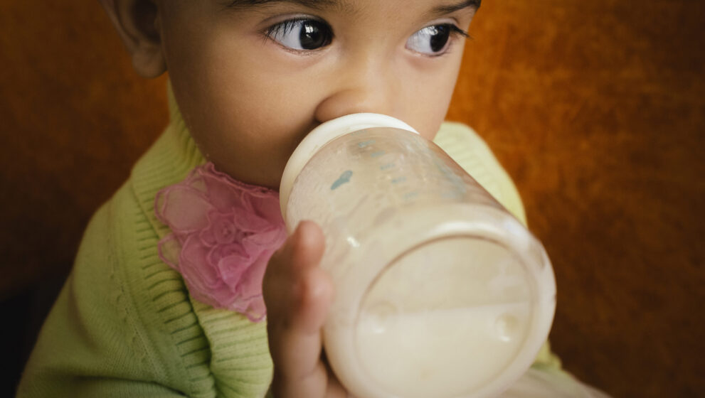 Closeup of a child drinking from a bottle