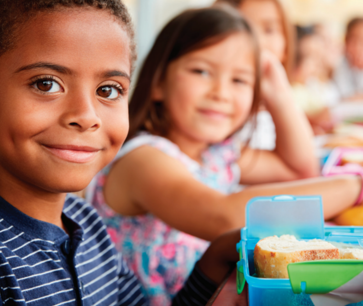 Children sitting at lunch table.