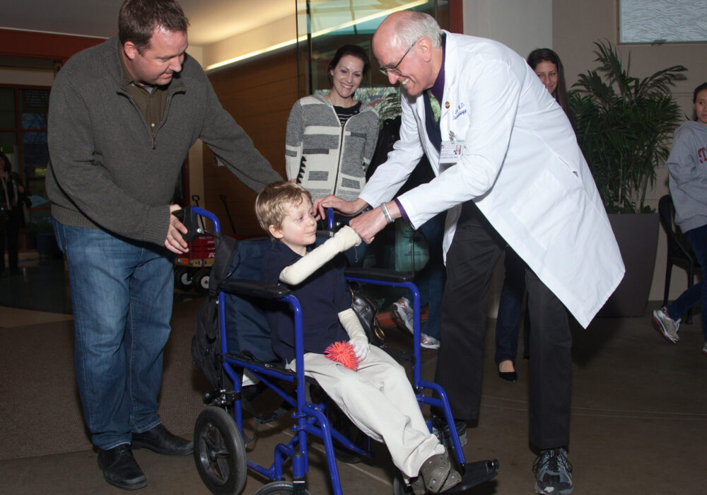 Dr Lane shaking the hand of an EB Patient