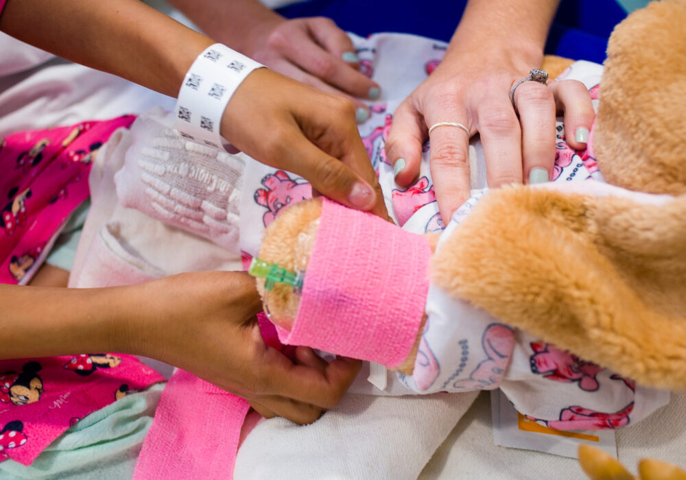 A teddy bear getting pretend medical treatment