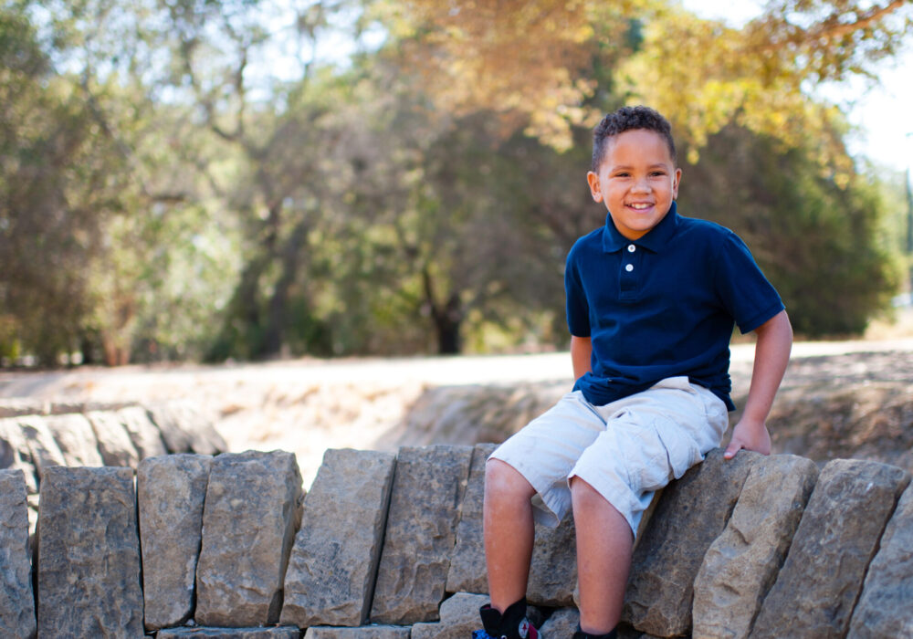 Leukemia patient Mateo Kohler smiles in a park.
