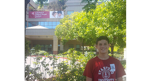 Pediatric patient standing in front of Lucile Packard Children's Hospital Stanford.