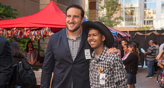 Two people standing next to each other for a picture.