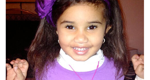 Young child smiling at camera.