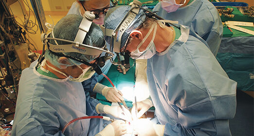 Surgeons performing surgery on a patient.