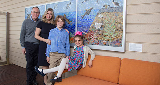 Two adults posing with two children.