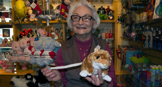 Elderly adult smiling at the camera.