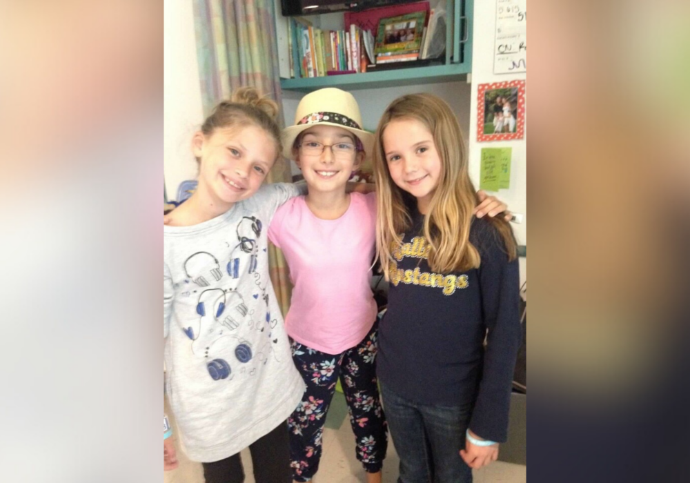 Mia and friends smiling at camera.