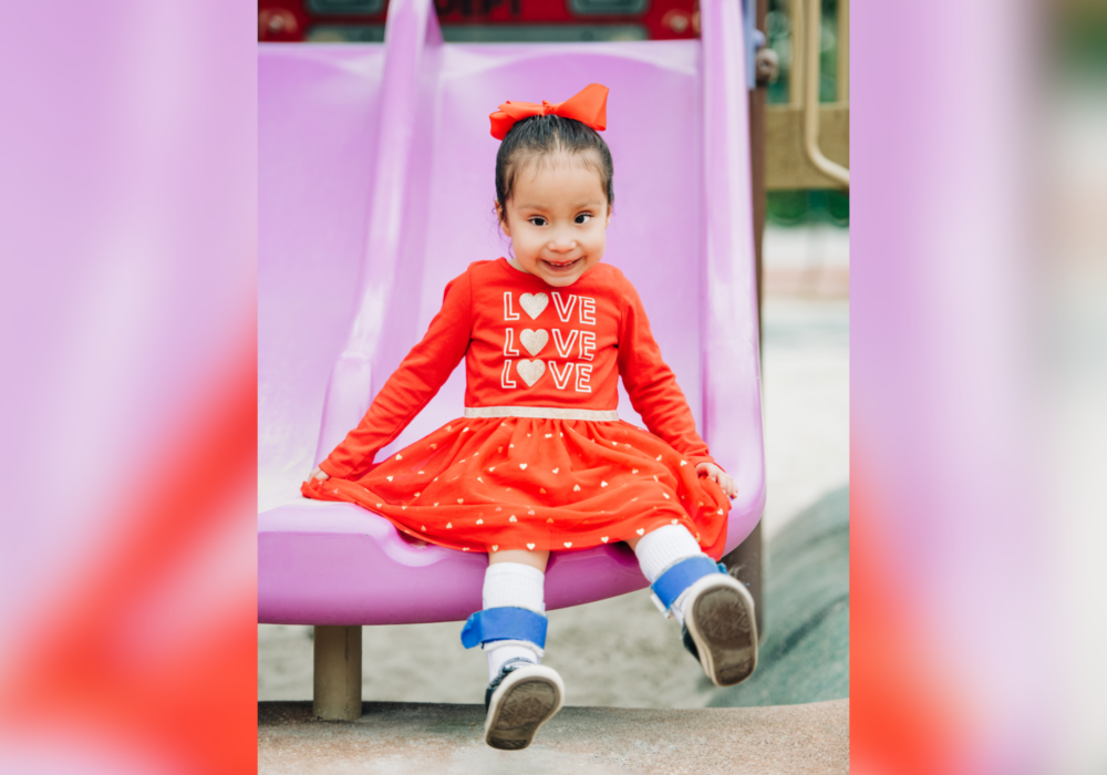Iliana playing on playground slide.