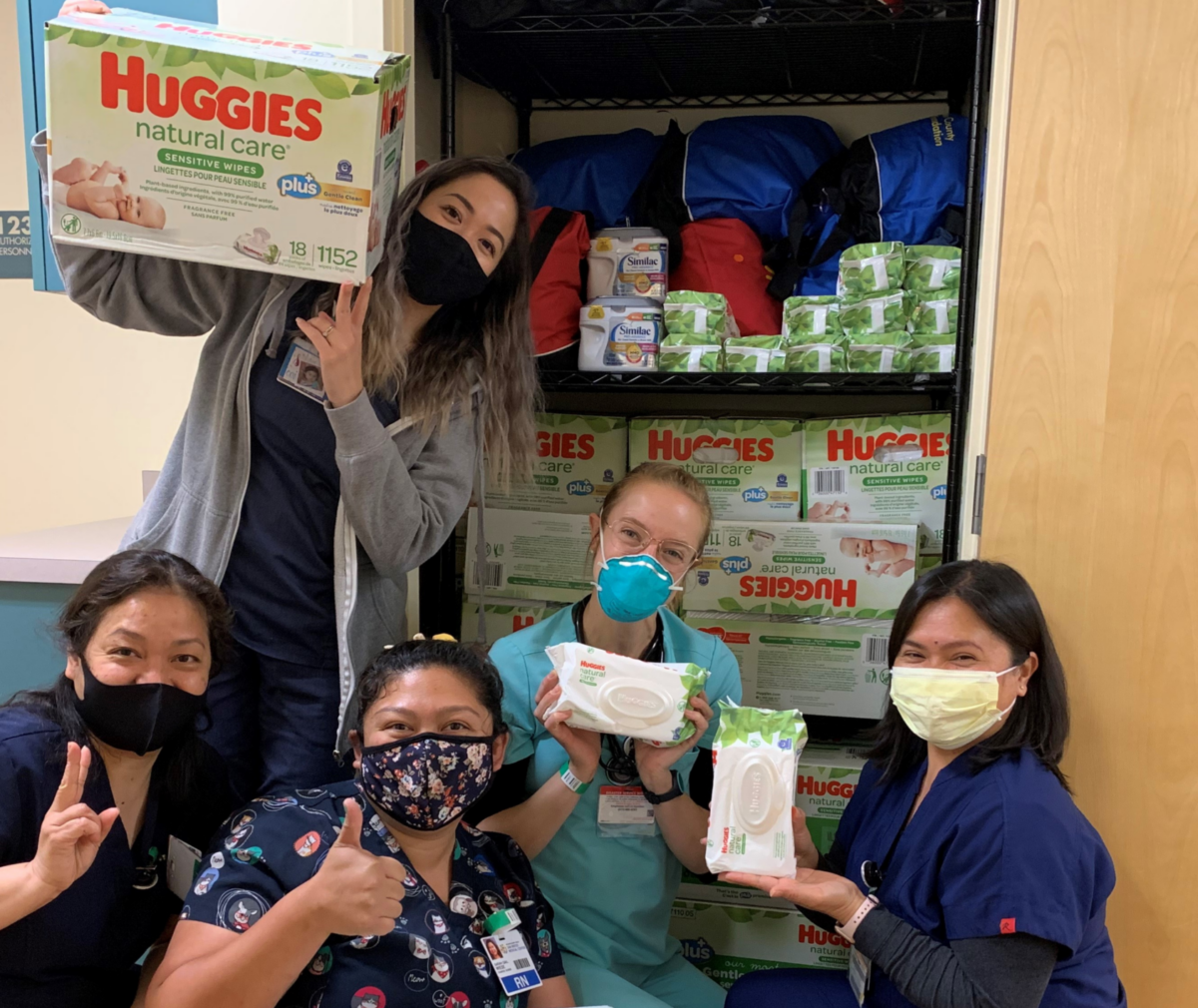 Volunteers at the Office of Child Health Equity with baby wipe donations.