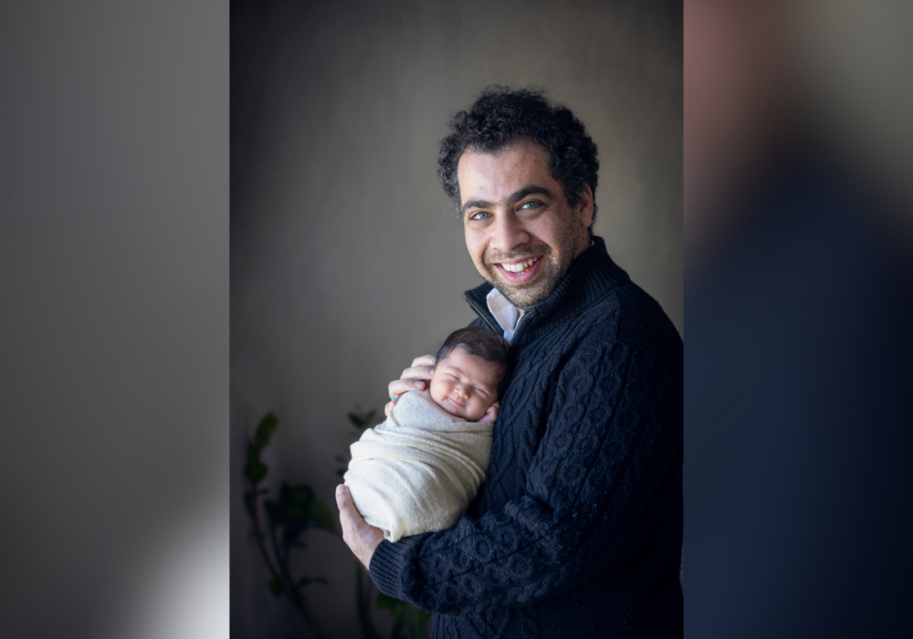 Nima holding newborn, Roya.
