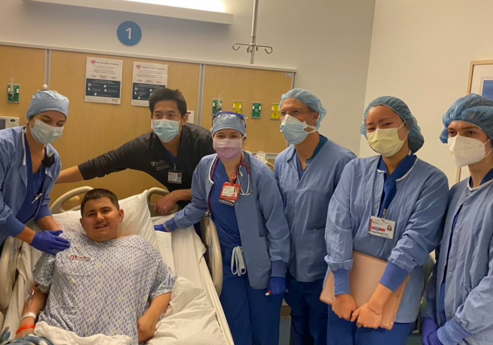Joseph and care team in hospital room.