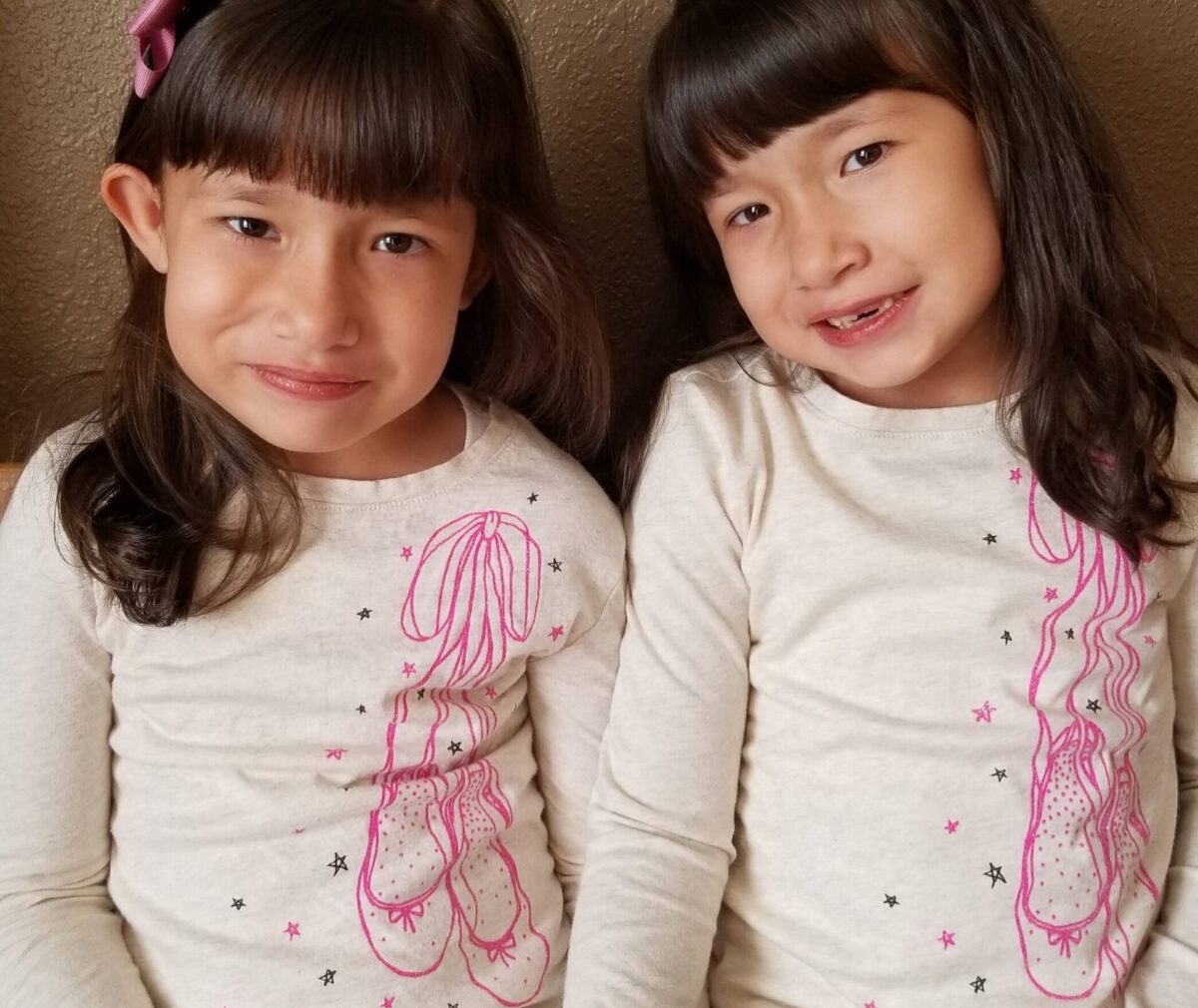 Two pediatric patients smiling at the camera.