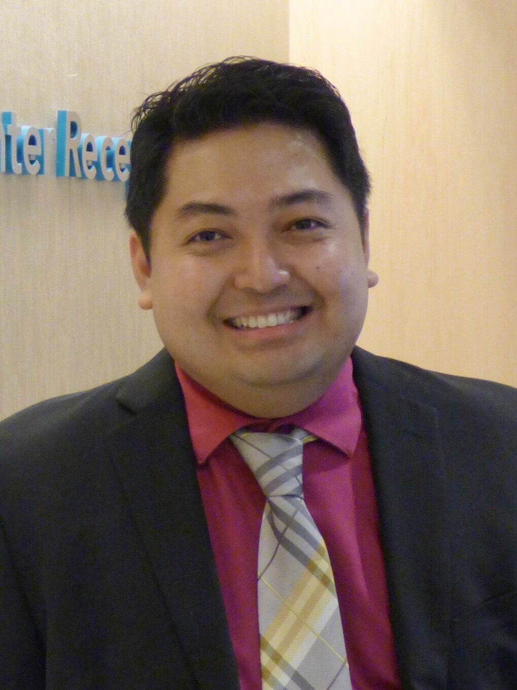 Adult smiling at the camera.
