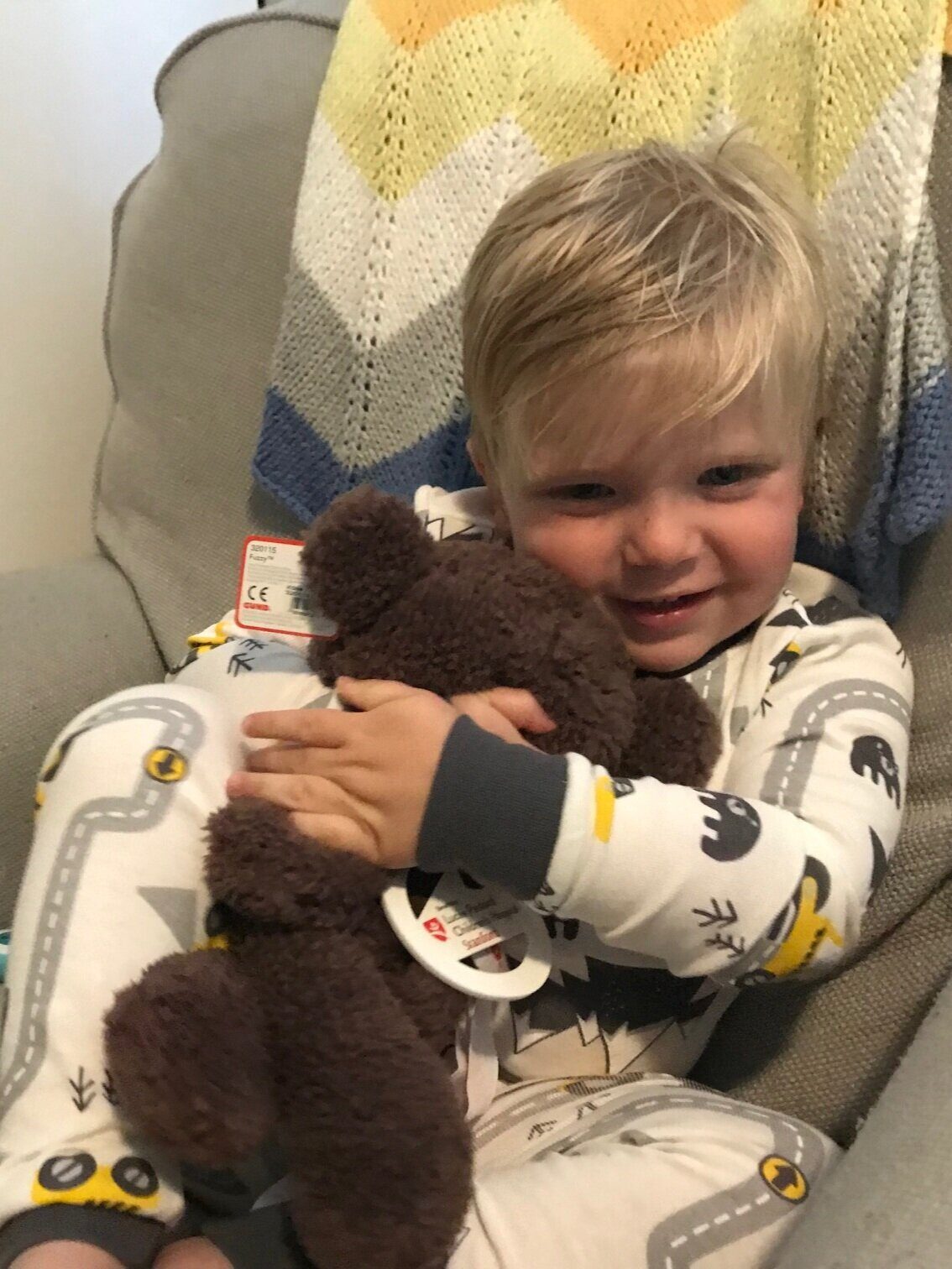 Toddler hugging stuffed animal.