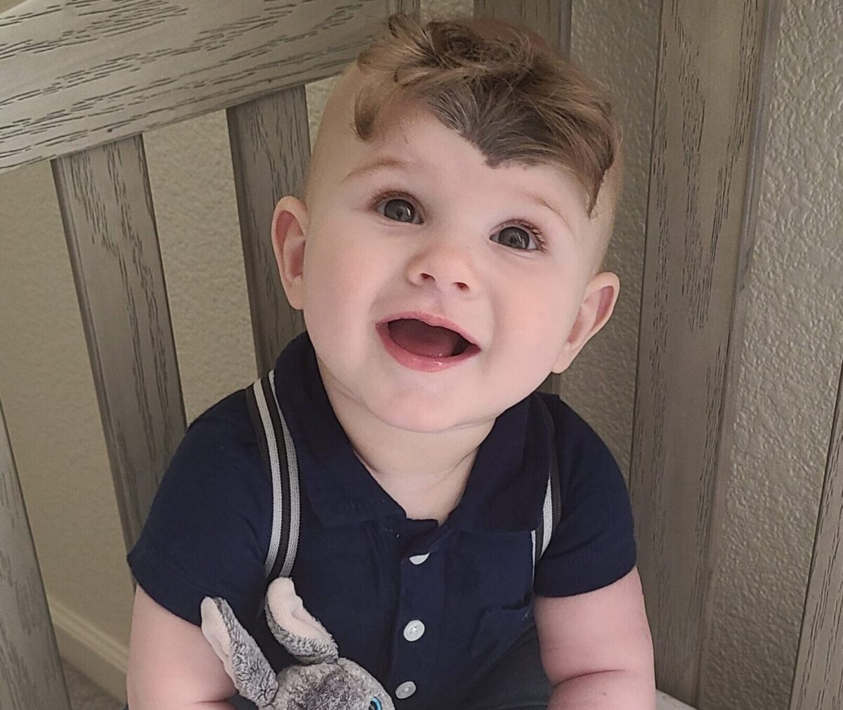 Weston smiling with stuffed bunny.