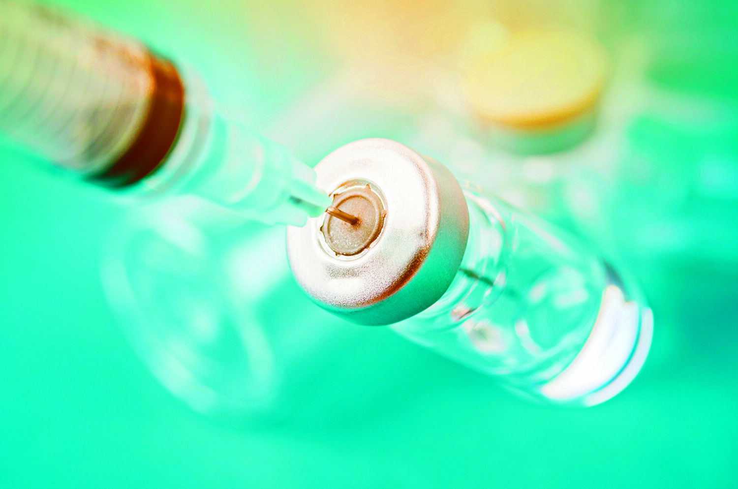 Stock photo of vaccine vial dose with needle syringe.