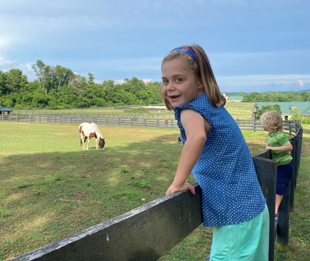 Abigail posed in front of a horse.