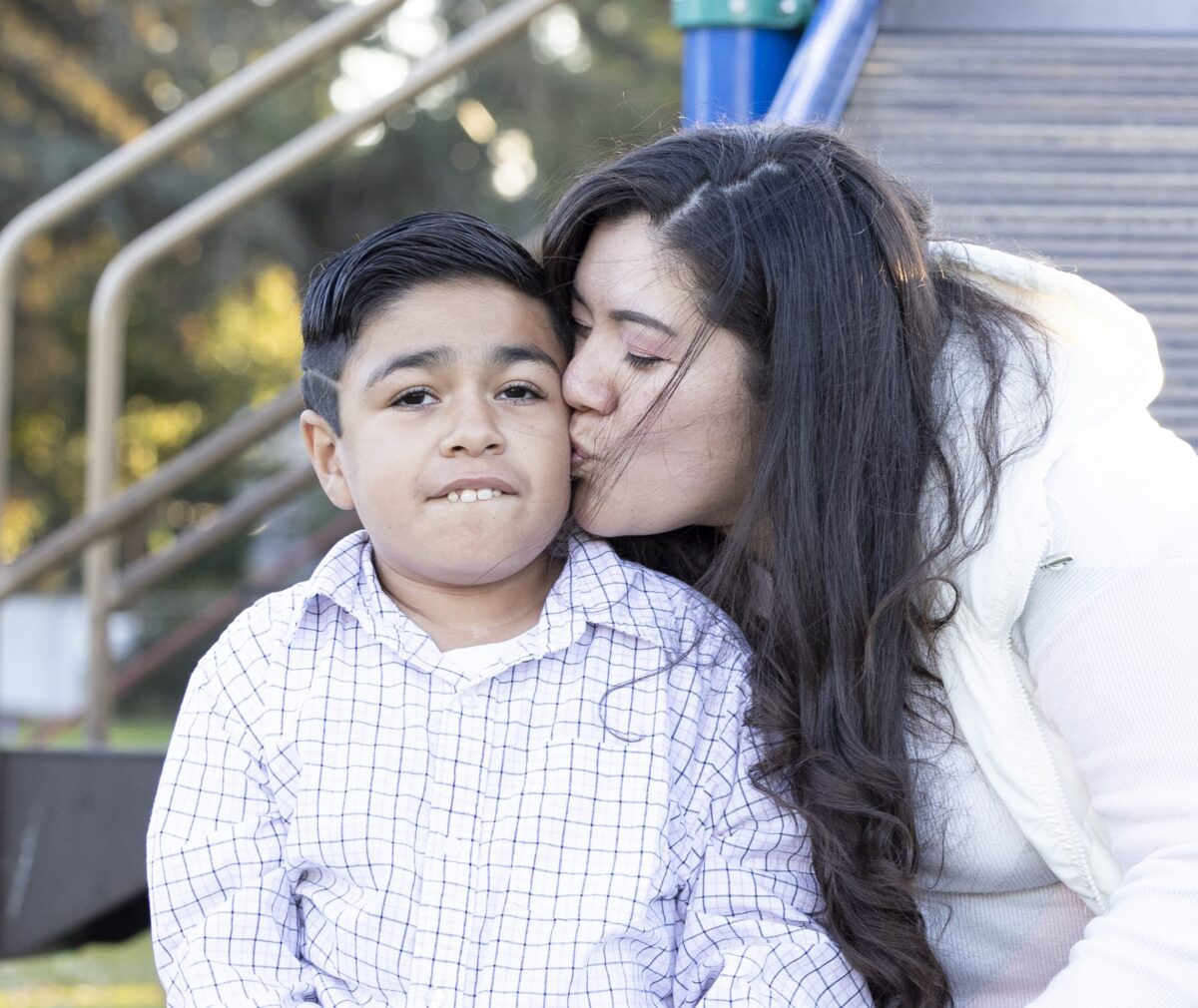Danae Aguilar gives her brother a kiss on the cheek.