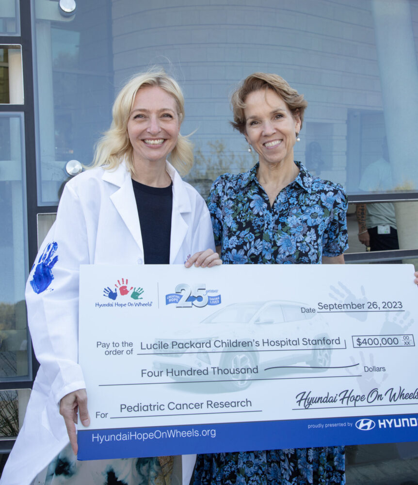 Doctors holding a check from Hyundai Hope on Wheels