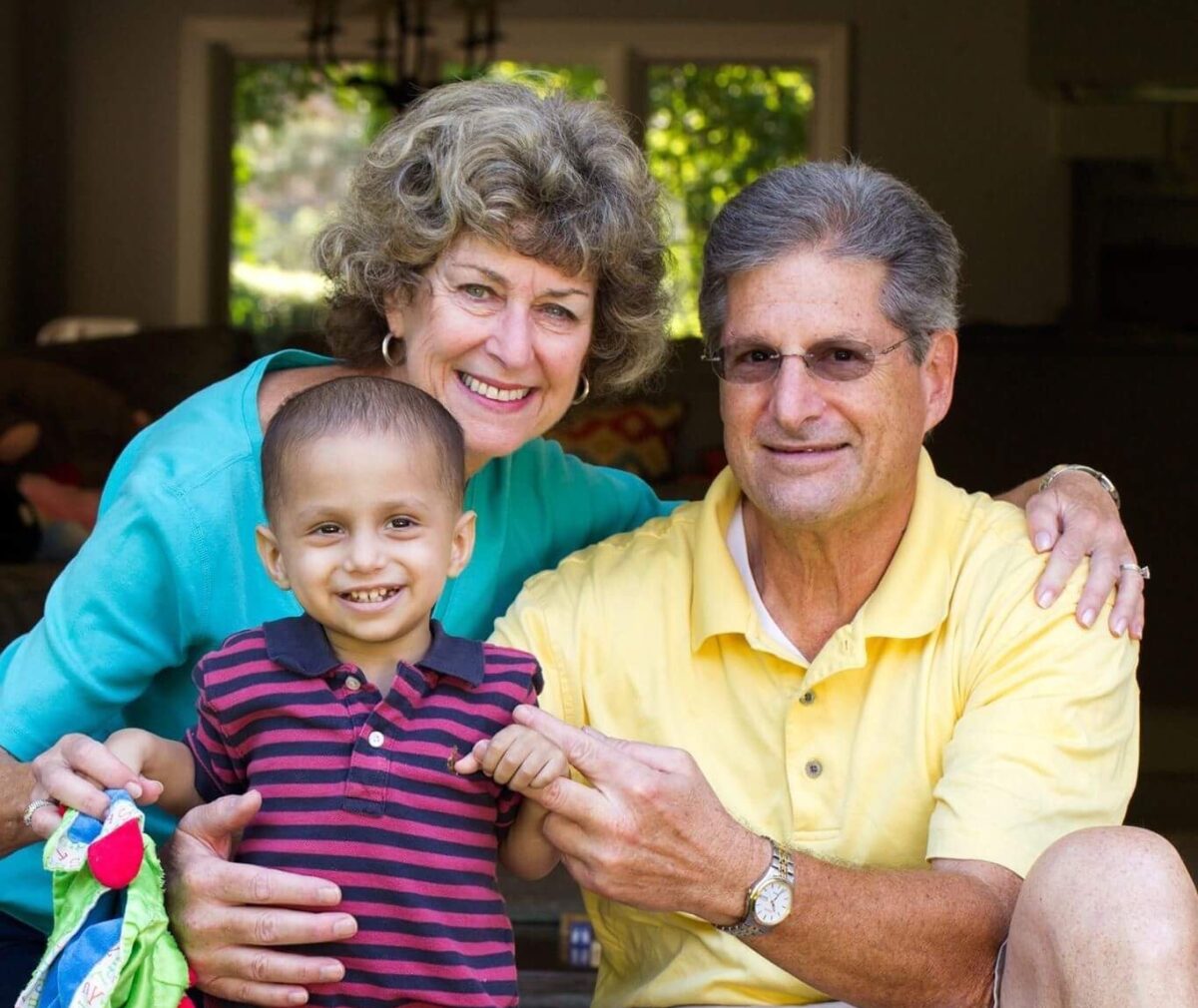 Grandparents holding their grandson.