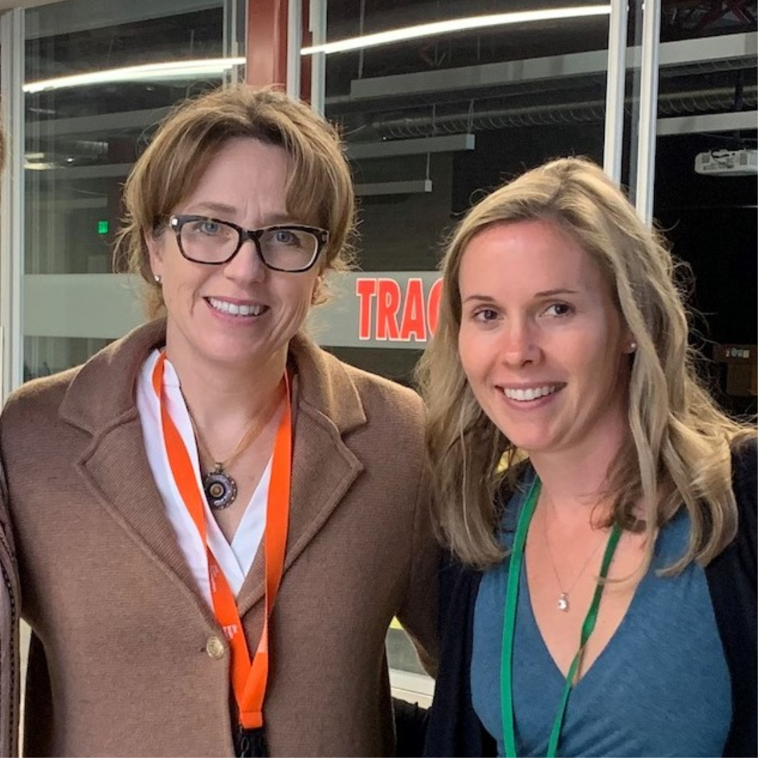 Two women smiling at the camera.