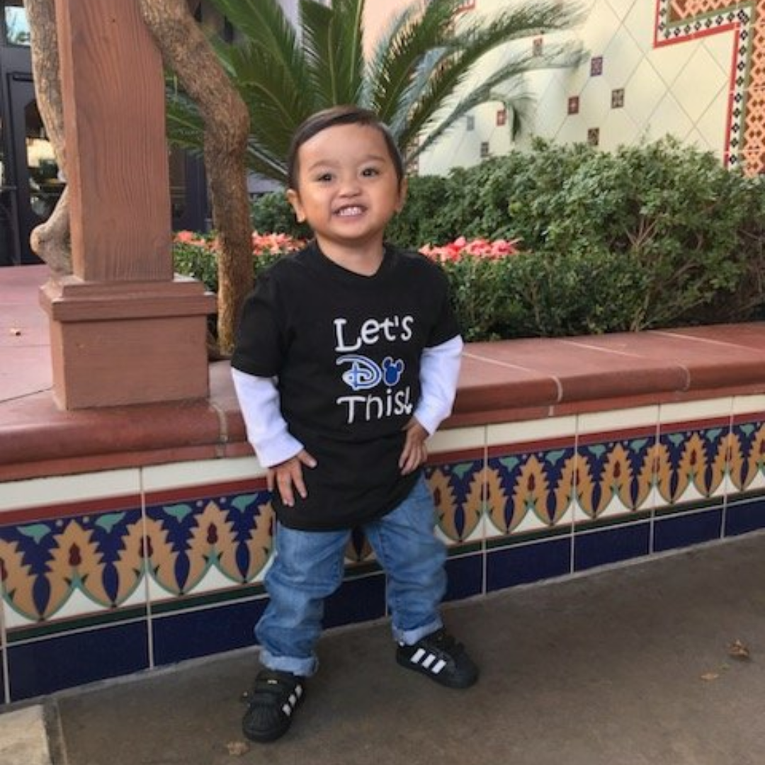 Little boy standing, smiling at the camera