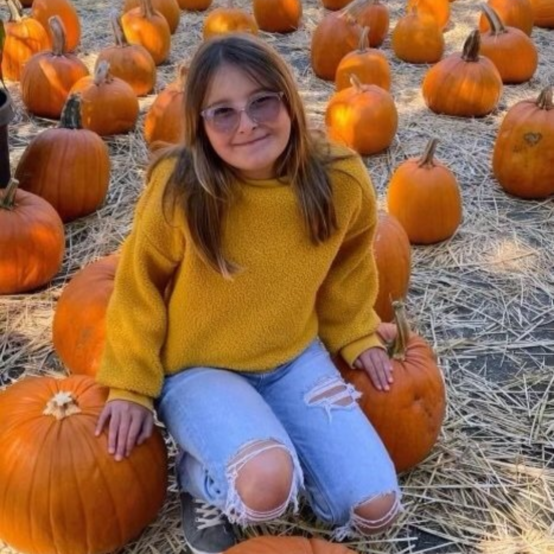 Anna Jo posed in a pumpkin patch.