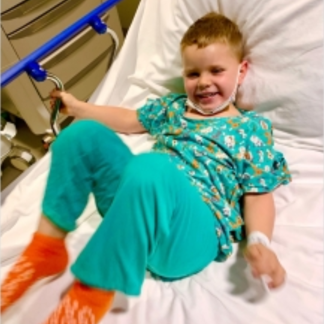 Boy smiling in hospital bed