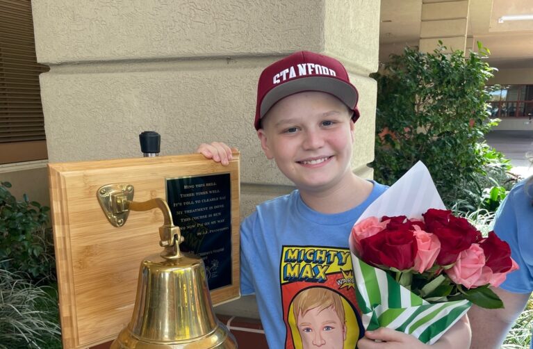 Patient Max posing with a bell.