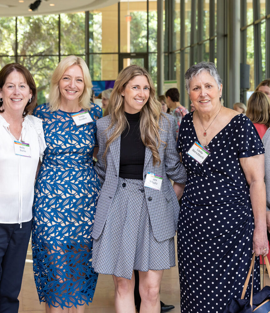 Group of auxiliary members pose with Dr Tanja Gruber at an event.
