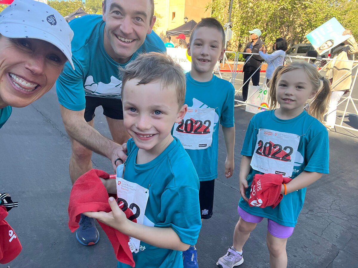 Siblings Matthew, Kate, and Alex posing with their parents at Summer Scamper.