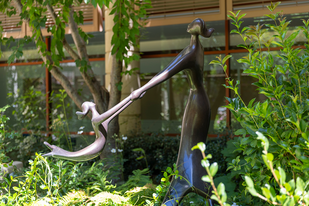 Sculpture of mother and child spinning in a circle outside of one of Lucile Packardshospital garden