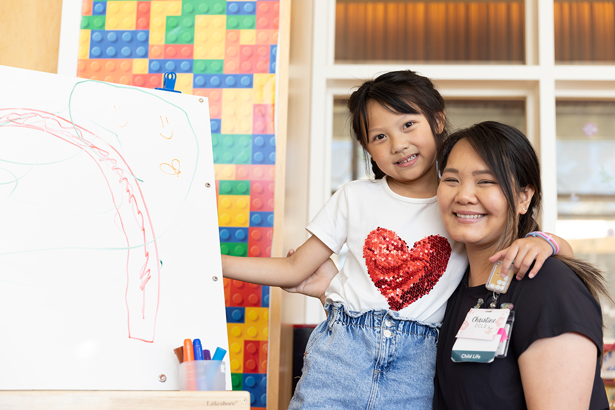 Christine Tao and young patient pose together at Lucile Packards Heart Center.