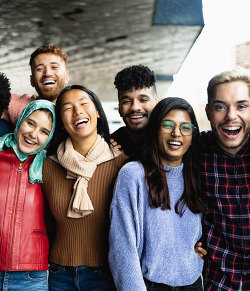 Group of young adults smiling together.