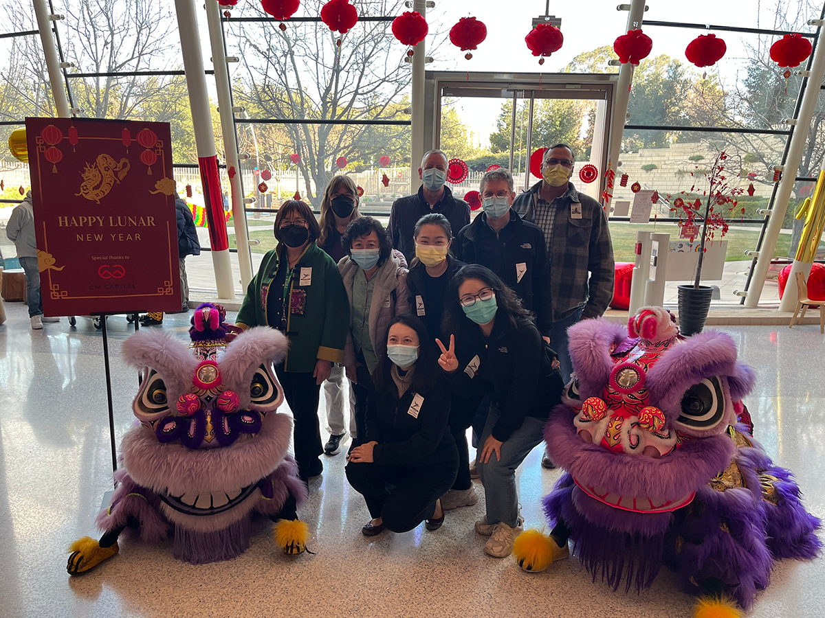 A group of people pose together at a lunar new year event at the hospital.